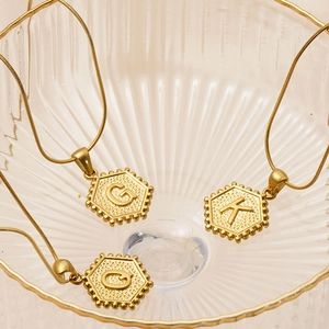 Golden 18K stainless steel necklaces with hexagonal G and K letter pendants for women