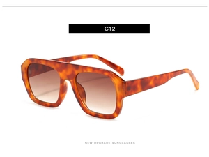 Detail view of large square tortoiseshell sunglasses with brown gradient lenses