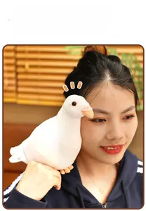 Close-up of soft white plush pigeon toy with realistic beak on a woman's shoulder