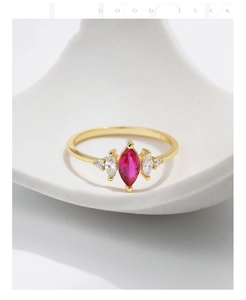 Detailed close-up of S925 silver marquise red ruby ring on a white ceramic stand