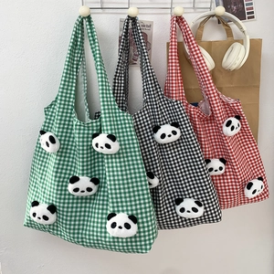 Detailed display of large plaid canvas tote bags with panda plush charms in three colors