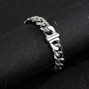 Macro detail of silver 13mm curb chain necklace featuring a secure square box clasp