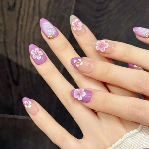 Handmade almond press-on nails with 3D floral relief and purple gradient design