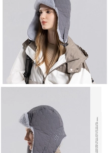 Close-up of gray quilted winter earflap hat with faux fur lining and adjustable drawstring