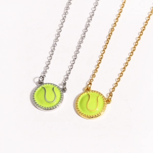 Detailed shot of gold and silver tennis ball pendant necklaces on O-chains