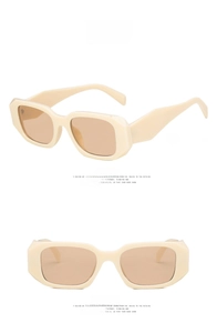Detail view of cream white rectangular sunglasses with light tea lenses and geometric temples
