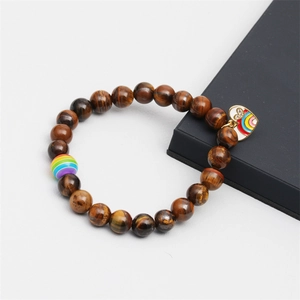 Close-up of tiger eye stone beads with rainbow charm and heart pendant detail
