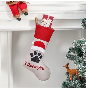 Beige fabric pet Christmas stocking with red I Ruff You text and paw prints on mantel
