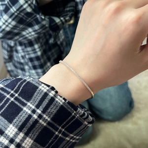 Detail shot of a minimalist S925 sterling silver geometric bracelet with sparkling zircons