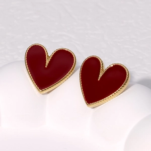 Elegant heart-shaped red enamel earrings with golden edges on a white background