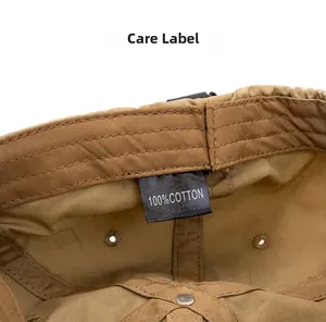 Close-up of 100% cotton wash label and breathable interior lining on khaki baseball cap