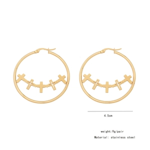 Detail view of 4.5cm gold stainless steel hoop earrings with five inner cross charms