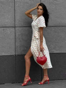 Detail of white cotton puff sleeve dress with red hearts and matching heart-shaped bag