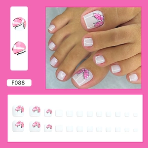 Detail of floral butterfly press-on toenails with pink patterns and purple glitter