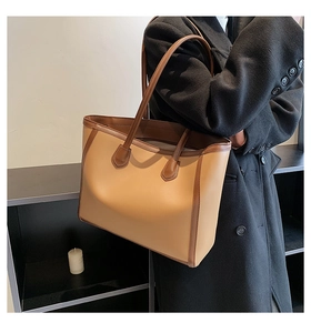 Detail view of khaki and brown PU leather tote bag with sturdy double handles