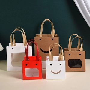 Multi-colored paper gift bags with smiley cut-outs and PVC windows in various sizes