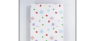 Detail view of a 42-piece Christmas ball gift box with red hearts and green stars