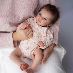 Realistic 18 inch Felicia baby doll with blue eyes in pink floral onesie outfit