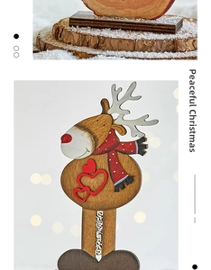 Detailed view of a wooden reindeer Christmas ornament with red scarf and heart detail