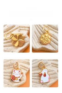 Detail of colorful enamel charms featuring clover, cat, and rabbit on stone base