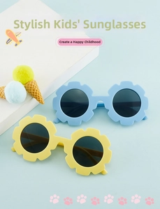Macro detail of sunflower shaped children sunglasses in pastel blue and yellow shades