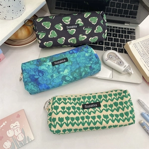 Floral canvas pencil cases with tulip patterns on a desk with stationery items