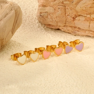 Minimalist gold heart earrings in assorted pastel colors on a natural stone base