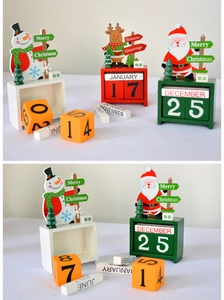 Detailed view of Christmas wooden block calendar featuring Santa, reindeer and snowman designs