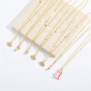 Minimalist gold-plated necklaces set with cute dinosaur and evil eye pendants
