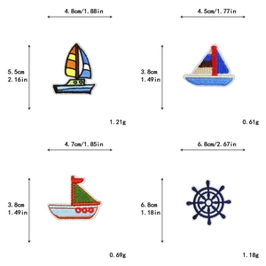 Detailed view of four nautical embroidery patches showing ship and wheel dimensions