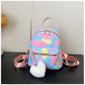 Close-up of tie-dye mini backpack with heart pendant and multiple zipper pockets