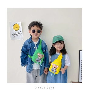Close-up of green and yellow cartoon bear crossbody chest bags worn by children