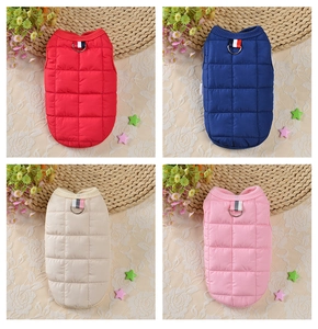 Detailed view of quilted pet vests with metal D-rings in four vibrant winter colors