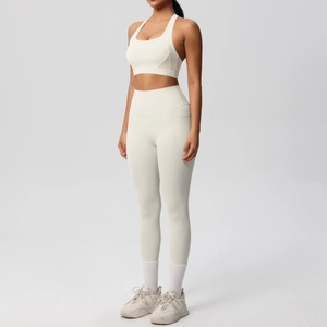 Detail of high-waist yoga leggings with side pockets and sports bra in cream white