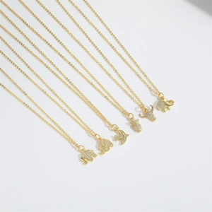 Delicate gold necklaces with crystal-encrusted elephant and bird animal pendants