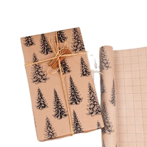 Brown kraft Christmas wrapping paper with black pine trees, jute rope, and grid cutting lines