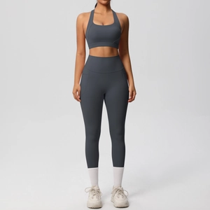 Detail of high-waist yoga leggings with functional side pockets and matching sports bra