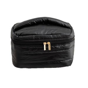 Glossy black quilted makeup bag with gold zippers and padded handle on white background