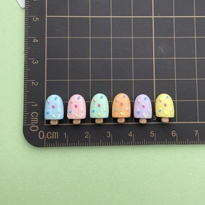 Detailed scale view of six colorful resin ice cream charms for DIY crafts and jewelry
