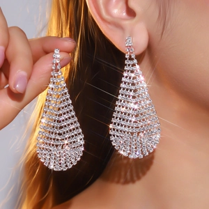 Sparkling silver long tassel drop earrings with crystals on a model in a close-up view