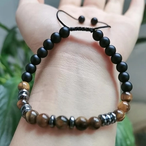 Detail of adjustable Morse code bracelet with tiger eye stones and matte black beads