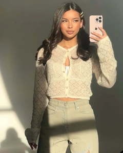 Detail of hollow knit texture on a beige single-breasted cardigan with a V-neckline