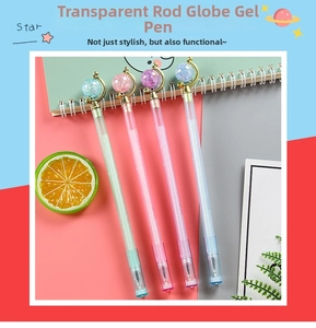 Close-up of cute pastel globe neutral pens with transparent barrels and glitter globes