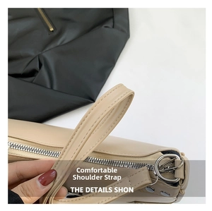 Detail of beige PU shoulder bag featuring silver zipper and reinforced strap stitching