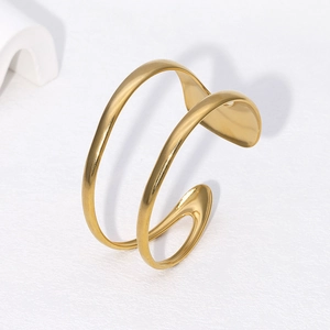 Minimalist double-layered wavy open bangle in 18k gold plated stainless steel on white texture