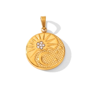 Close-up of 18K gold sun and moon pendant with sparkling cubic zirconia on white backdrop