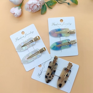 Colorful acetate leopard print hair clips on white display card with flower decor