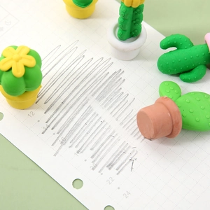 3D cactus shaped erasers in colorful pots on a grid notebook with pencil drawings