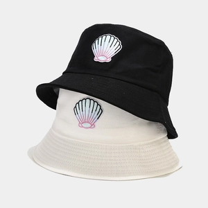 Minimalist bucket hat in black and beige with a colorful gradient shell embroidery patch
