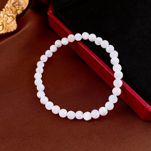 Detail of round shell pearl beaded elastic bracelet on a luxurious velvet jewelry box